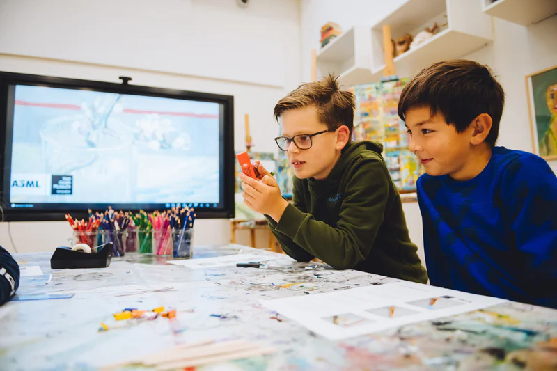 Twee jongens experimenteren net als Van Gogh met kleur en licht tijdens het lesprogramma Masterminds & Masterpieces